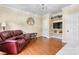 Cozy living room featuring hardwood floors, a comfortable leather couch, and built-in shelving at 4007 Lake Shore S Rd, Denver, NC 28037
