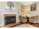 Inviting living room with a fireplace, elegant chairs and hardwood floors at 4007 Lake Shore S Rd, Denver, NC 28037