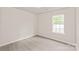 Bright bedroom featuring a window and modern flooring at 425 Austin Dr, Charlotte, NC 28213
