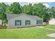 Quaint home featuring neat lawn, blue shutters, and a welcoming pathway to the front door at 425 Austin Dr, Charlotte, NC 28213