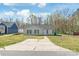 Charming single-story home featuring blue shutters, a concrete driveway, and a well-maintained front lawn at 425 Austin Dr, Charlotte, NC 28213