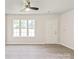 Sunlit living space featuring wood-look flooring, a ceiling fan, and a view of the outdoors at 425 Austin Dr, Charlotte, NC 28213