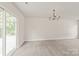 Bright living room with sliding glass doors and a decorative chandelier at 425 Austin Dr, Charlotte, NC 28213