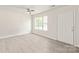 Bright living room featuring neutral walls, wood-look floors, and a modern ceiling fan at 425 Austin Dr, Charlotte, NC 28213