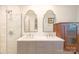 A luxurious bathroom is complete with double sinks, marble countertops, and modern gold fixtures at 4526 Longwood Dr, Charlotte, NC 28209