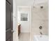 This renovated bathroom has decorative wallpaper, and a tub/shower combination at 4526 Longwood Dr, Charlotte, NC 28209