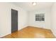 This bedroom features warm hardwood floors, a neutral color scheme, and a window for natural light at 4526 Longwood Dr, Charlotte, NC 28209
