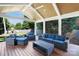 An attractive covered patio with ample seating invites relaxation with a scenic view of the manicured lawn at 4526 Longwood Dr, Charlotte, NC 28209