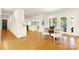 Open-concept dining room with hardwood floors and a modern chandelier at 4526 Longwood Dr, Charlotte, NC 28209