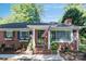 Charming brick home with an American flag, manicured landscaping and brick entryway at 4526 Longwood Dr, Charlotte, NC 28209