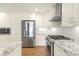 Modern kitchen with stainless steel appliances, granite countertops, and white subway tile backsplash at 4526 Longwood Dr, Charlotte, NC 28209