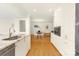 Open kitchen with white cabinets, granite countertops, and stainless-steel appliances at 4526 Longwood Dr, Charlotte, NC 28209