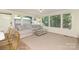 Bright sunroom features oversized windows, a large sectional, and access to the home's exterior at 4526 Longwood Dr, Charlotte, NC 28209