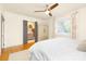 This bright primary bedroom features hardwood floors, a ceiling fan and an ensuite bathroom at 4526 Longwood Dr, Charlotte, NC 28209