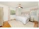 Relaxing bedroom features a king bed, overhead ceiling fan, large window, and neutral color palette at 4526 Longwood Dr, Charlotte, NC 28209