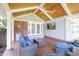 Covered back patio has wooden floors, tongue and groove ceiling, an outdoor television, and patio furniture at 4526 Longwood Dr, Charlotte, NC 28209