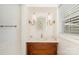 Charming powder room features patterned wallpaper, white marble countertop, and a vintage style vanity at 4526 Longwood Dr, Charlotte, NC 28209