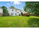 Spacious backyard with green grass, white house, wooden deck and fence at 4982 Bentgrass Run Dr, Charlotte, NC 28269