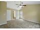 Neutral bedroom with vaulted ceilings and view into adjoining bathroom at 4982 Bentgrass Run Dr, Charlotte, NC 28269