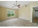 Neutral bedroom with vaulted ceilings, ceiling fan, and large windows for ample lighting at 4982 Bentgrass Run Dr, Charlotte, NC 28269