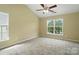 Neutral bedroom with vaulted ceilings, ceiling fan, and large windows for ample lighting at 4982 Bentgrass Run Dr, Charlotte, NC 28269