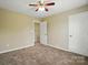 Comfortable bedroom features neutral paint, carpet, closet, and a door at 4982 Bentgrass Run Dr, Charlotte, NC 28269
