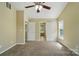 Neutral bedroom with vaulted ceilings, ceiling fan, and multiple closets and entryways at 4982 Bentgrass Run Dr, Charlotte, NC 28269