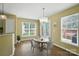 Bright dining area featuring a round table and chairs illuminated by a modern chandelier at 4982 Bentgrass Run Dr, Charlotte, NC 28269