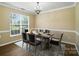 Formal dining room featuring wood floors, ample natural light, and chandelier at 4982 Bentgrass Run Dr, Charlotte, NC 28269
