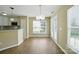 Bright dining area adjacent to kitchen featuring natural light and wood floors at 4982 Bentgrass Run Dr, Charlotte, NC 28269