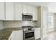 Modern kitchen featuring stainless steel appliances, white cabinetry, and a subway tile backsplash at 4982 Bentgrass Run Dr, Charlotte, NC 28269