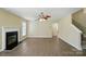 Comfortable living room featuring a fireplace, ceiling fan, and wood-look flooring at 4982 Bentgrass Run Dr, Charlotte, NC 28269