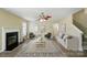 Inviting living room with a cozy fireplace, neutral decor, and ample seating at 4982 Bentgrass Run Dr, Charlotte, NC 28269
