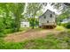 Exterior view of home, with wooden deck, a spacious backyard and landscaping at 513 Sacco St, Belmont, NC 28012
