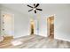 Spacious bedroom featuring light gray walls, a ceiling fan and luxury vinyl plank flooring at 513 Sacco St, Belmont, NC 28012