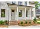 Inviting front porch with white columns and brick accents on a modern home at 513 Sacco St, Belmont, NC 28012