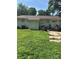 Back view of the house, showing a small patio, side entrance and partial backyard at 5200 Queen Anne Rd, Charlotte, NC 28217