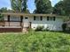Attractive single-story house featuring a cozy front porch and well-maintained exterior at 5200 Queen Anne Rd, Charlotte, NC 28217