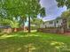 Backyard showcasing a well-maintained lawn, storage shed, and fenced perimeter for added privacy at 5436 Topping Pl, Charlotte, NC 28209
