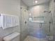 This bathroom features a glass shower with marble tile and a built-in shower niche at 5436 Topping Pl, Charlotte, NC 28209