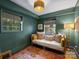 Stylish daybed featuring neutral pillows, lamp lighting, and natural light at 5436 Topping Pl, Charlotte, NC 28209