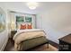 Bright bedroom featuring a comfortable bed, stylish decor, and large windows offering ample natural light at 5436 Topping Pl, Charlotte, NC 28209