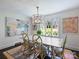 The dining room has a decorative chandelier, large windows, and a colorful area rug at 5436 Topping Pl, Charlotte, NC 28209