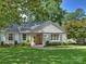 Charming white brick home featuring manicured landscaping and shuttered windows at 5436 Topping Pl, Charlotte, NC 28209