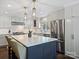 Modern kitchen featuring stainless steel appliances, white cabinets and a center island at 5436 Topping Pl, Charlotte, NC 28209