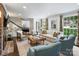 Bright and airy living room with hardwood floors, a brick fireplace, and ample seating at 5436 Topping Pl, Charlotte, NC 28209