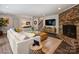 Cozy living room with a fireplace, sectional sofa, and stylish decor at 5436 Topping Pl, Charlotte, NC 28209