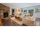 Spacious living room with a brick fireplace, white sofa, and sliding barn door at 5436 Topping Pl, Charlotte, NC 28209