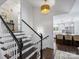Staircase view towards the kitchen and seating area with hardwood floors at 5436 Topping Pl, Charlotte, NC 28209