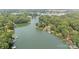 Expansive aerial view of a lakefront property surrounded by lush greenery and other luxurious homes at 6836 Summer Hill Dr, Denver, NC 28037